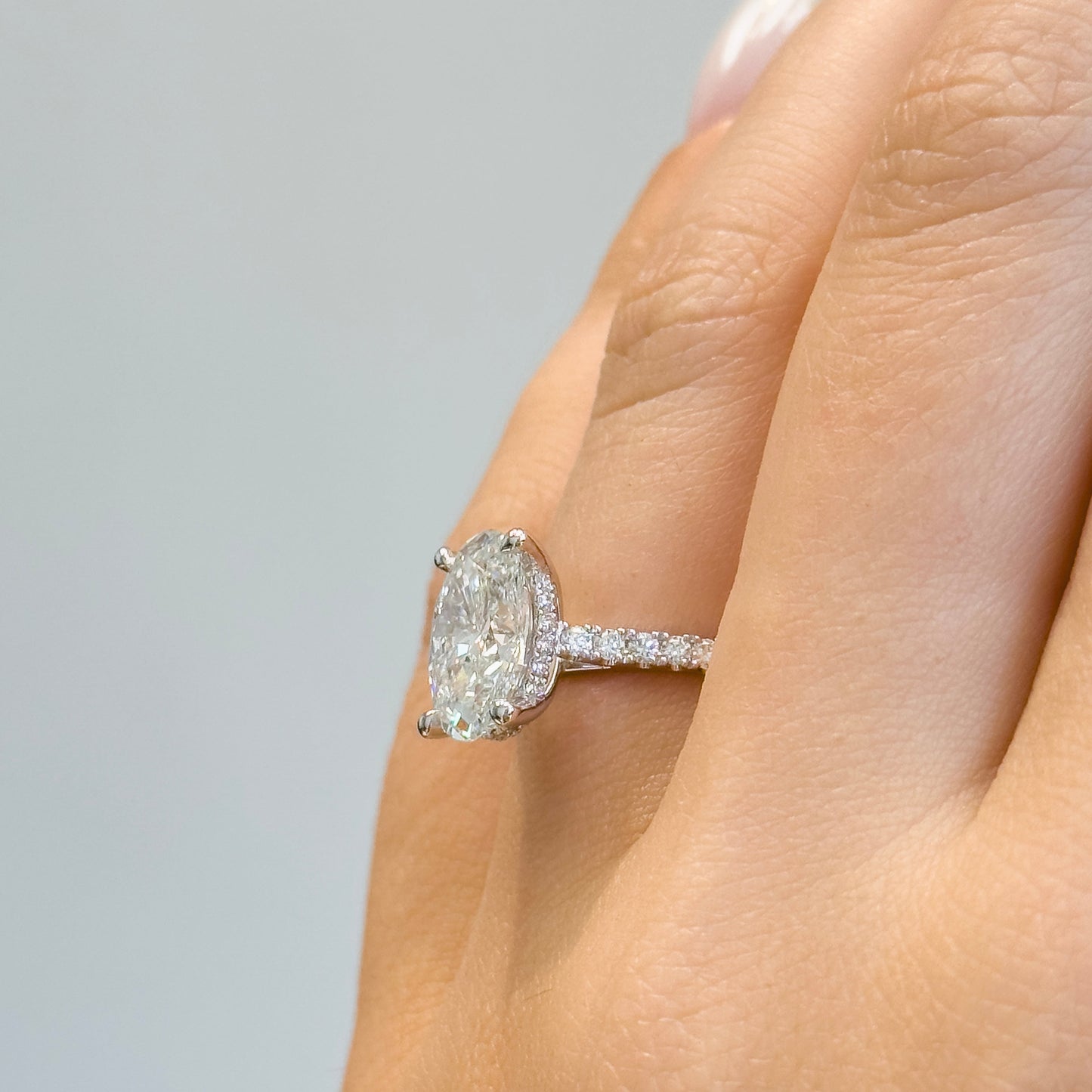 Oval Cut Diamond Engagement Ring with Cathedral Setting and Hidden Halo